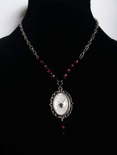 "Beautiful Goth Halloween spider antique silver Cabochon Necklace with Black and Red crystal beads make up 3\" of chain. Black and Red crystal beads dangles from the pendant also.  Great for gifts for her, Fall, Halloween or maybe a special gift for yourself. Measurements: Necklace Varies Beads on chain 3\" pendant 2\"" Gothic Halloween Jewelry With Round Pendant, Gothic Halloween Round Pendant Jewelry, Red Nickel-free Jewelry For Halloween, Antique Silver Jewelry For Halloween Gift, Nickel-free Red Halloween Jewelry, Goth Necklaces, Red Goth, Goth Halloween, Goth Necklace