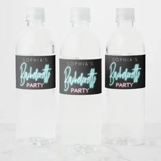 three bottled water bottles with labels on them