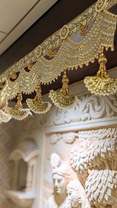 an intricately decorated ceiling with gold chains hanging from it