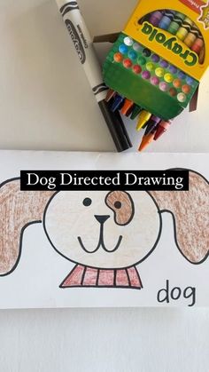 a dog is drawn with colored crayons next to a box of crayons