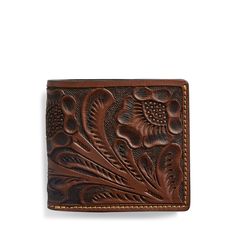 a leather wallet with an intricate design on the front