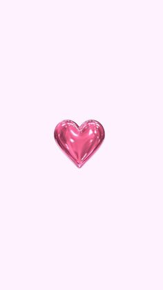 a pink heart shaped object sitting on top of a table