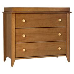 a wooden dresser with three drawers and gold knobs on the bottom drawer, against a white background