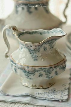 two white and blue dishes sitting on top of a table