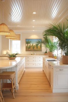 a large kitchen with white cabinets and wood flooring on the walls is pictured in this image