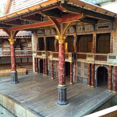 an elaborately decorated stage with pillars and arches in the center, surrounded by wooden flooring