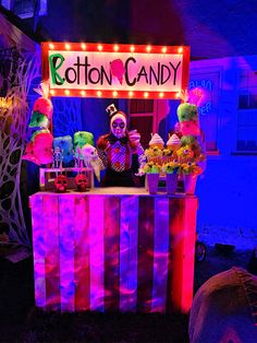 a booth that has some kind of candy on it with lights and decorations around it