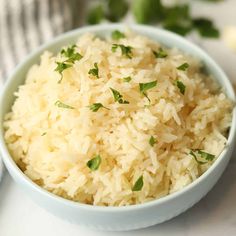 a white bowl filled with rice on top of a table