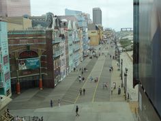 people are walking down the street in front of buildings