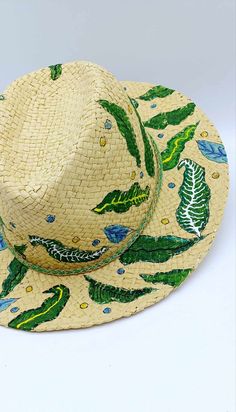 Grab this cool and stylish straw hat, hand-painted with bohemian leaves on the rim and top. It's light, flexible, and super comfy, perfect for any occasion -- beach days, brunch, or just hanging out outdoors. Head size: 58 Each hat is carefully hand-painted with love and great attention to details, making every piece truly unique. The hat can be customized  to match your creative vision. Artisan Panama Hat For Spring Beach, Artisan Panama Hat For Beach In Spring, Artisan Panama Hat For Spring Vacation, Artisan Fedora For Spring Vacation, Artisan Fedora For Beach In Spring, Bohemian Fedora Sun Hat For Garden Party, Artisan Hat For Spring Vacation, Artisan Spring Vacation Hat, Bohemian Natural Panama Hat For Garden Party