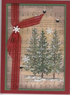 a christmas card with a red ribbon on it and a tree in the background,