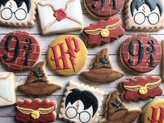 harry potter themed cookies are arranged on a wooden table, with the number nine in front of them