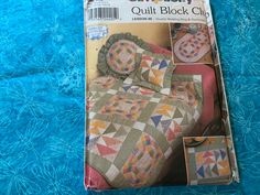 the quiltery book is open to show it's cover and features an image of a quilted bed