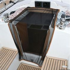 the inside of a boat with wooden flooring and windows on it's sides