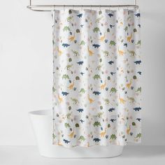 a shower curtain with dinosaurs on it