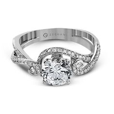 a white gold engagement ring with an oval cut diamond