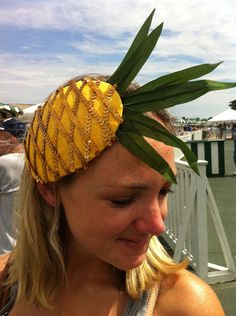 a woman wearing a pineapple headband on top of her head