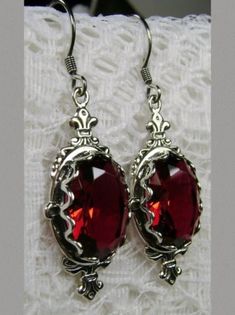 These are sterling silver Victorian reproduction earrings set with flawless simulated gemstones. Each stunning man made 6 carat gem is 14mm long and 10mm wide. The earrings are 1.75" long and marked 925 for sterling silver. Red Ruby Earrings, Ruby Necklace Pendant, Pin Earrings, Pin Design, Ruby Pendant, Floral Brooch, Red Jewelry, Ruby Earrings, Sterling Silver Filigree