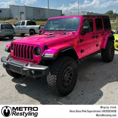 a bright pink jeep parked in a parking lot