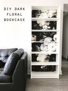 a black and white flowered bookcase next to a leather chair in a living room