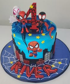 a birthday cake with spiderman decorations on it