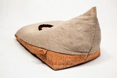 a close up of a wooden shoe on a white surface with a cork bottom and heel