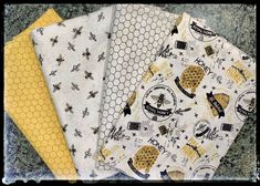 four bees and honeycombs on white fabric