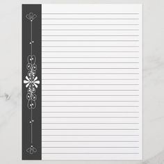 a black and white lined notepad with flowers on it