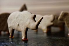 small wooden animals are lined up on the table