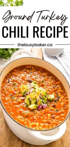 a white bowl filled with beans and avocado on top of a wooden table