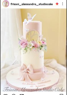 a white and pink wedding cake with flowers on the top is featured in an instagram