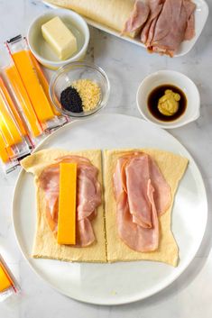 two slices of bread with cheese and ham on them, surrounded by other food items