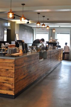 an empty restaurant with people sitting at the counter