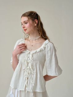 This blouse from Linennaive is all about romance and vintage vibes. Crafted from soft linen in a casual silhouette. Ruffle trim and puffed sleeves evoke the Victorian era, adding signature dramatic to the design.Pleated detailing creates an elegant, sophisticated look. Ties at the front add a playful touch to the piece Victorian Blouse, Ruffle Linen, Victorian Vintage, Elegant Sophisticated, Vintage Linen, Puff Sleeve Blouse, Linen Blouse, Puffed Sleeves, Dress With Cardigan