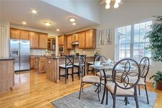 a kitchen and dining room with hardwood floors