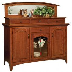 a wooden cabinet with two vases on top of it and a mirror above the door