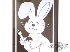 a drawing of a rabbit holding a carrot in front of a brown and white background