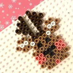 several different colored spools sitting on top of a white surface with snowflakes in the background