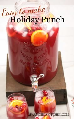 two glasses filled with cranberry punch and garnished with orange slices