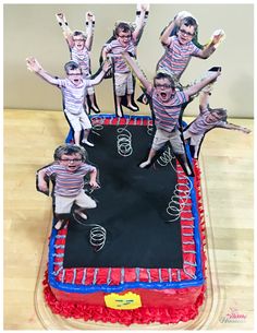 a birthday cake that looks like it is made to look like kids jumping on a trampoline