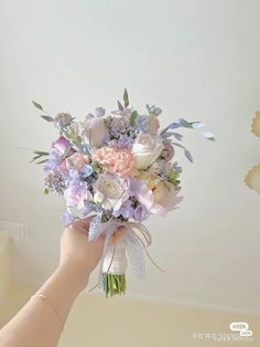 a person holding a bouquet of flowers in their hand