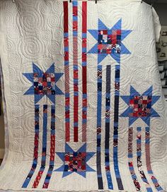 an american flag quilt hanging on a wall