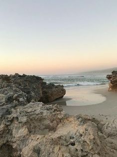 the beach is covered in rocks and sand