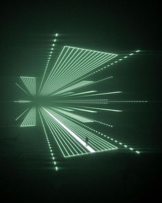 an image of a green light in the middle of a dark room with lights coming from it