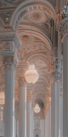 the interior of a building with columns and chandeliers on either side of it