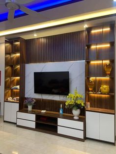 a living room filled with furniture and a flat screen tv on top of a wooden entertainment center