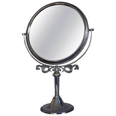 a round mirror sitting on top of a metal stand in front of a white background