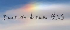 the words dare to dream big are written in black ink on a rainbow colored cloud