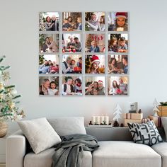 a white couch sitting next to a christmas tree in front of a wall with pictures on it