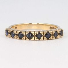 a yellow gold ring with blue sapphire stones